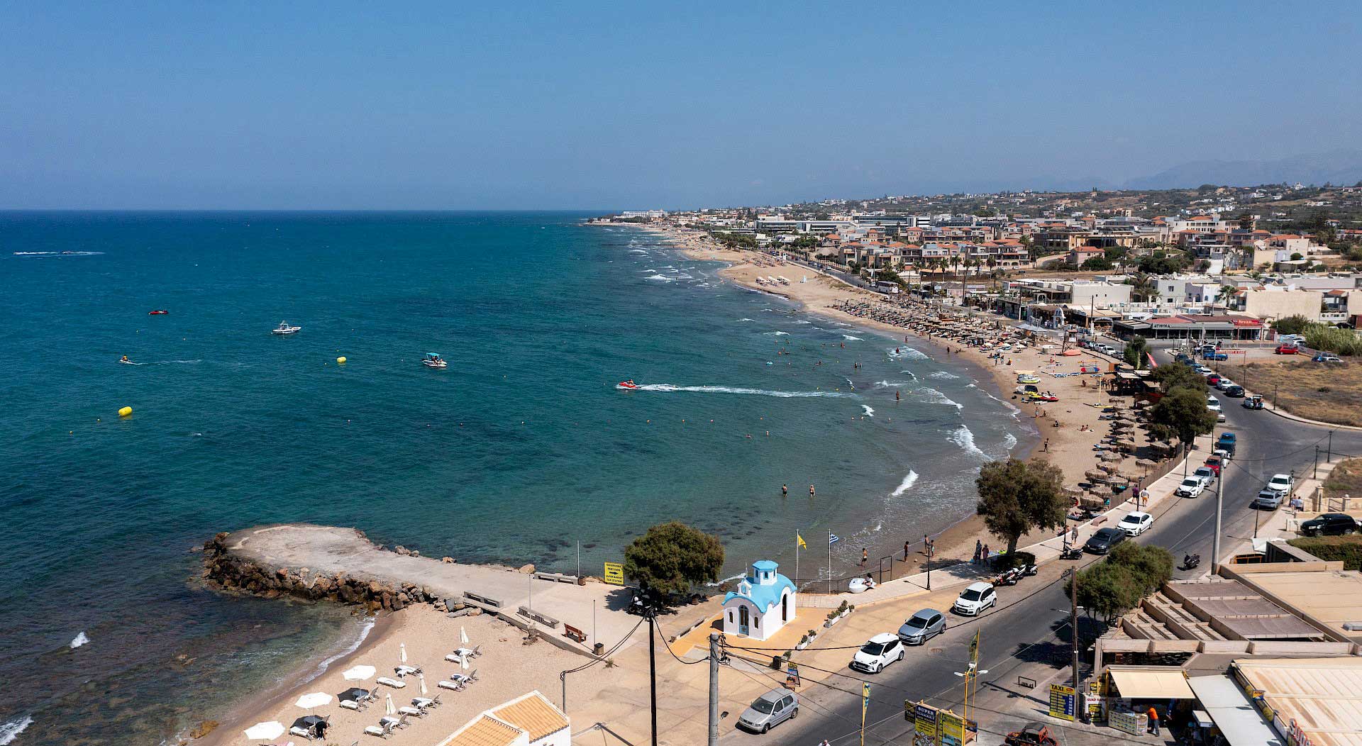 Analipsi beach and promenade from above — long sandy shore on Crete's north coast